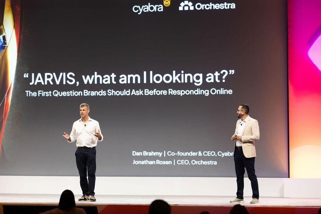 Two speakers on a conference stage with a slide titled 'JARVIS, what am I looking at?'